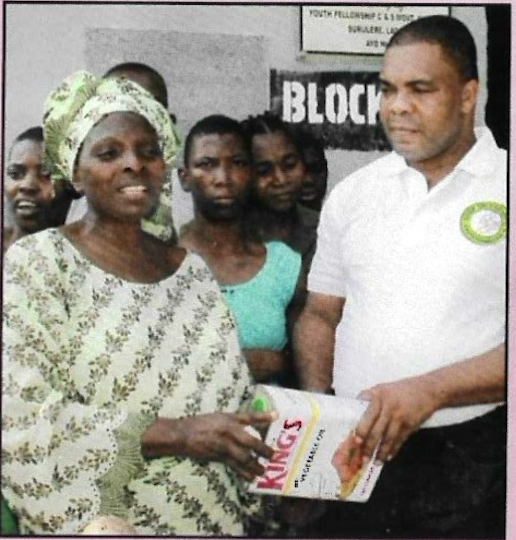 Volunteers handing over food items and household supplies
