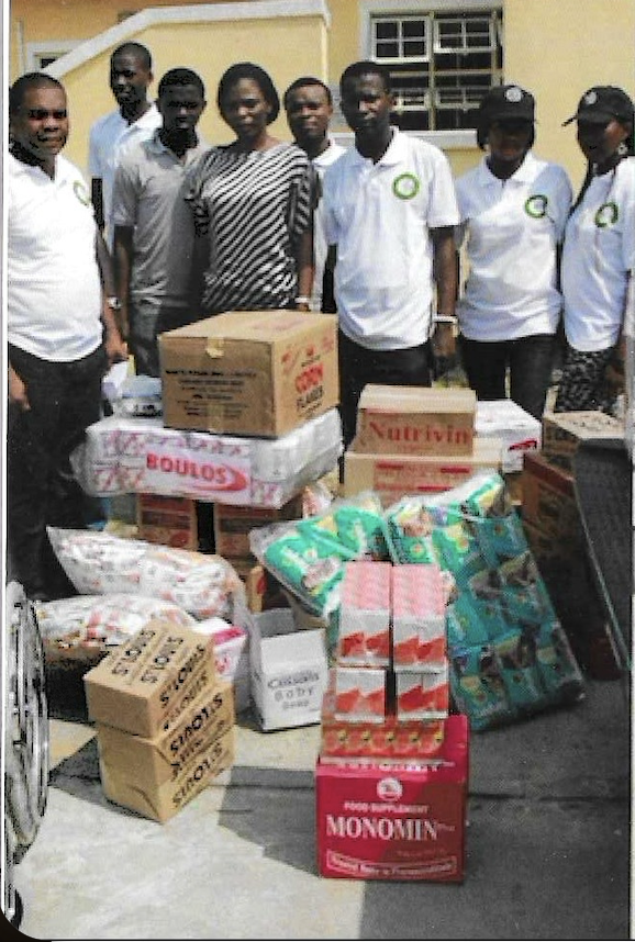 Volunteers with children and caregivers at the home