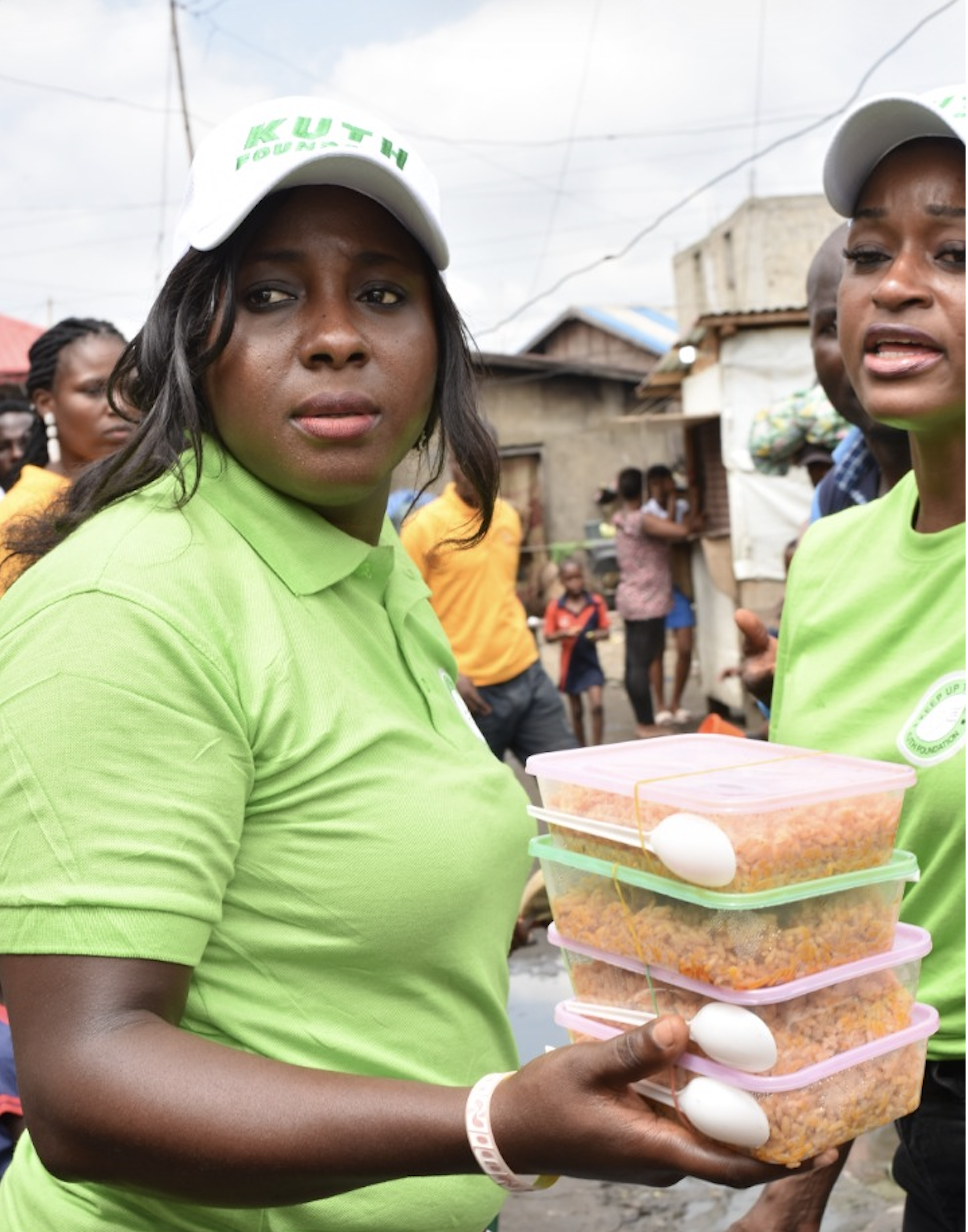 KUTH volunteers with food containers at Makoko