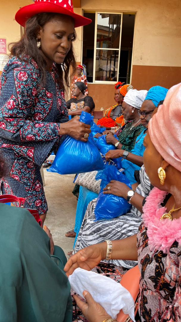Close-up of volunteer handing bag to widow