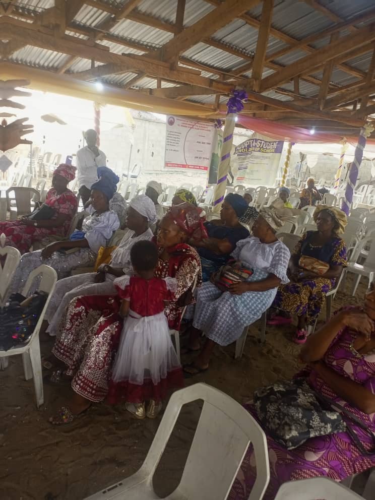 Widows seated with church banners in background