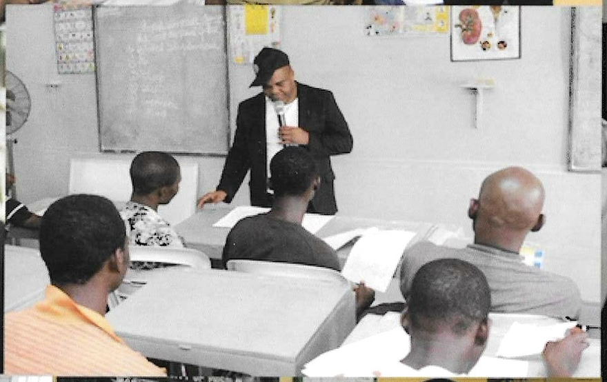 Senior Director of Programs Prince Francis Chilaka leading a session for inmates, 2012 prison outreach