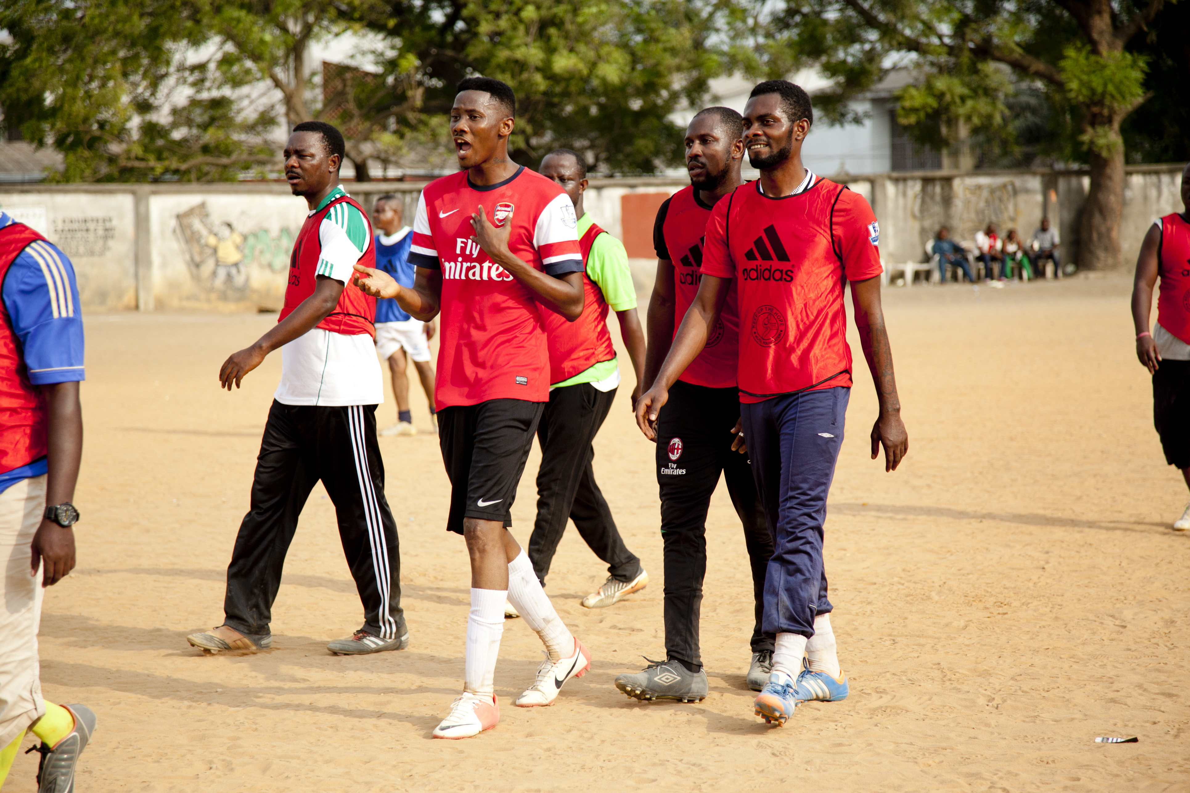 Players in red jerseys walking on pitch