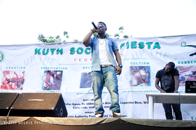 Artiste performing on stage with anti-vice awareness banner